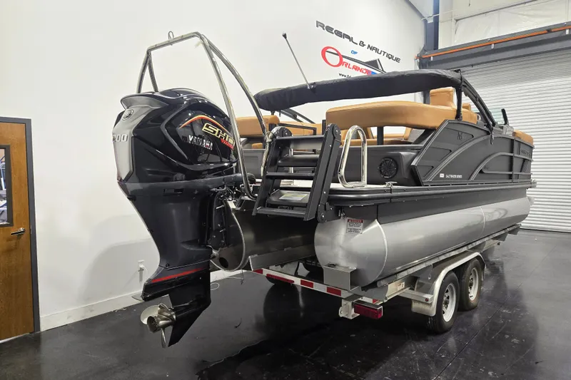 Slide: The Image of 2026 Bennington 22M Open FSB pontoon boat with Yamaha outboard motor on trailer. - 3