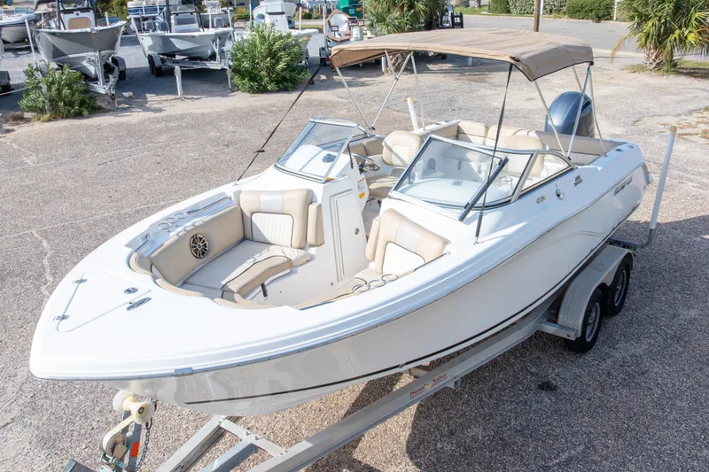 Slide: The Image of 2016 Sea Fox 226 Traveler boat on trailer, featuring beige seating and canopy. - 4