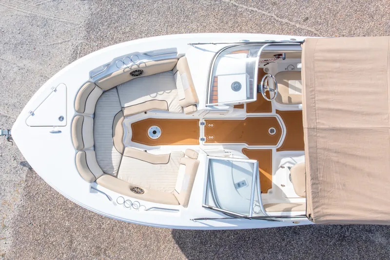 Slide: The Image of 2016 Sea Fox 226 Traveler boat interior with beige seating and brown flooring, aerial view. - 9