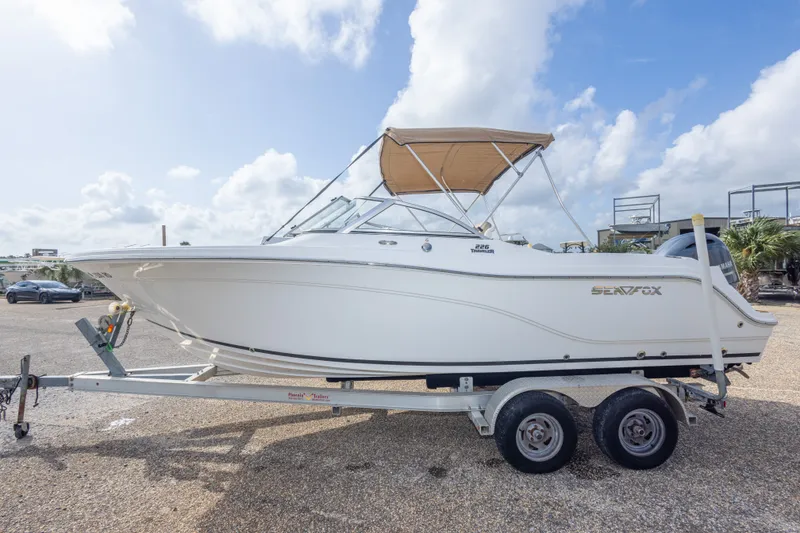 Slide: The Image of 2016 Sea Fox 226 Traveler boat on trailer under clear sky. - 19