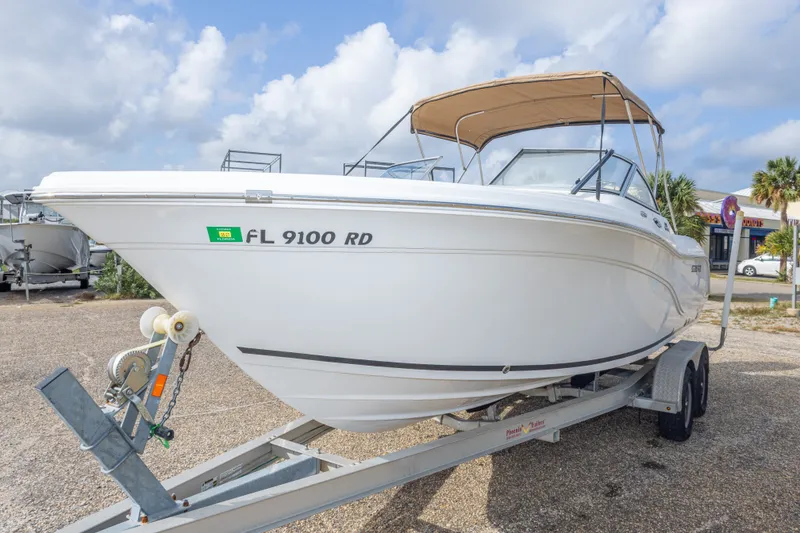 Slide: The Image of 2016 Sea Fox 226 Traveler boat on trailer, parked outdoors under cloudy sky. - 20