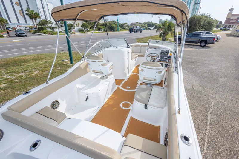 Slide: The Image of 2016 Sea Fox 226 Traveler boat with beige seating and canopy, parked near a road. - 24