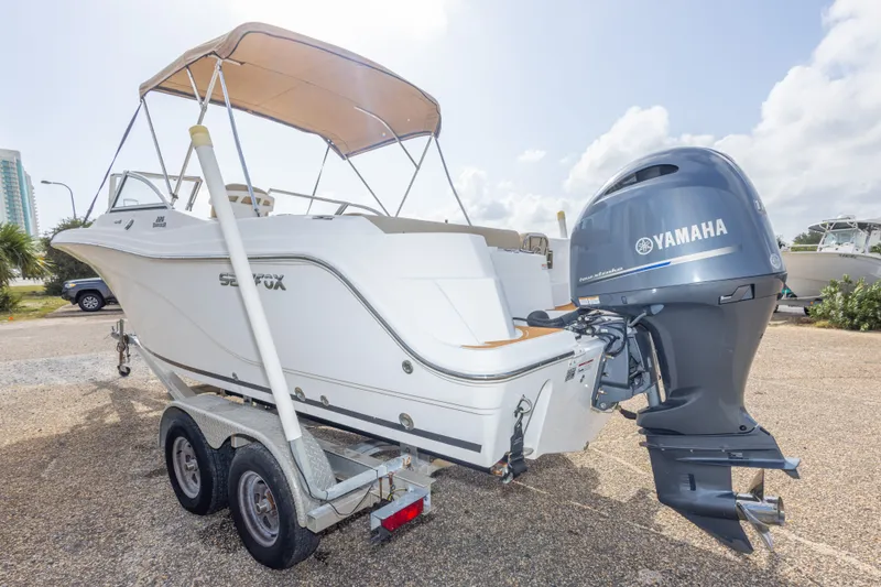 Slide: The Image of 2016 Sea Fox 226 Traveler boat with Yamaha engine on a trailer, parked outdoors. - 18