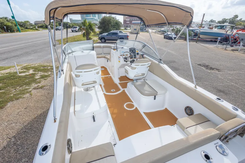 Slide: The Image of 2016 Sea Fox 226 Traveler boat with beige seating and canopy, parked near a road. - 25