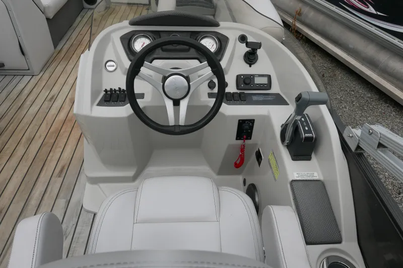 Slide: The Image of Steering console of a 2018 Crest II boat with controls and gauges. - 9