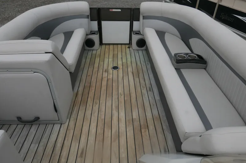 Slide: The Image of Spacious interior of 2018 Crest II pontoon boat with comfortable seating and wooden flooring. - 6