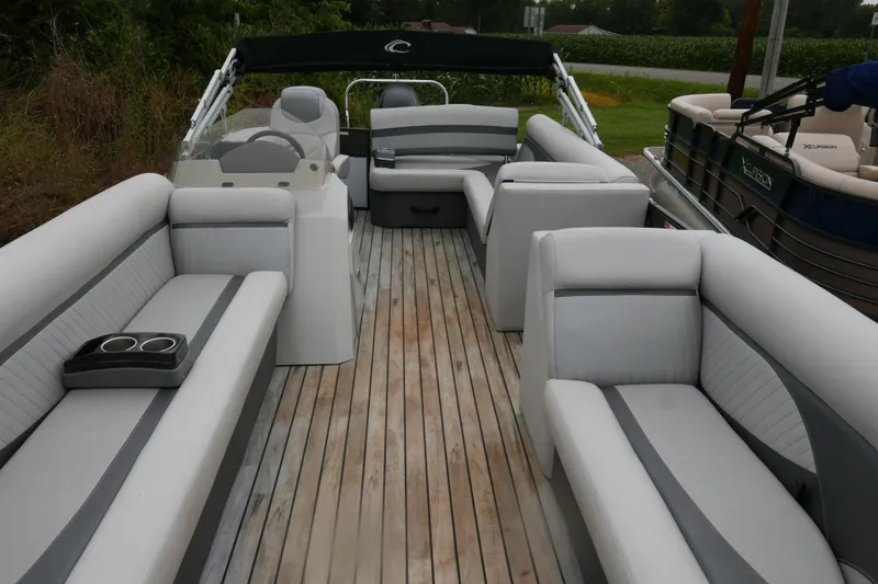 Slide: The Image of 2018 Crest II pontoon boat with spacious seating and wooden deck. - 3