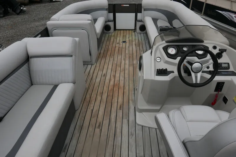 Slide: The Image of Interior of a 2018 Crest II pontoon boat with plush seating and modern controls. - 11