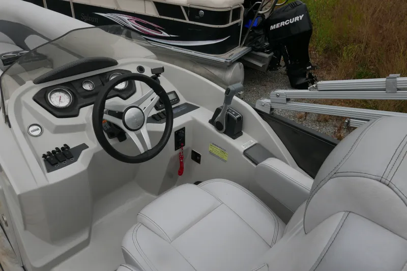 Slide: The Image of 2018 Crest II boat cockpit with steering wheel and control panel. - 8