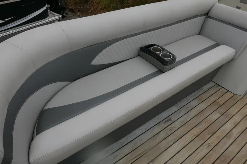 Slide: The Image of 2018 Crest II boat seating with cup holders on wooden deck. - 5