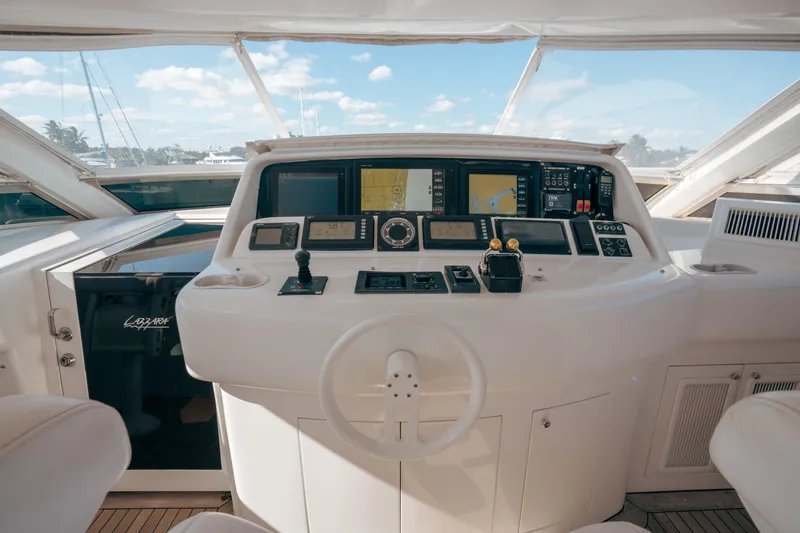Slide: The Image of Cockpit of 2004 Lazzara 106 yacht with navigation instruments and steering wheel. - 23