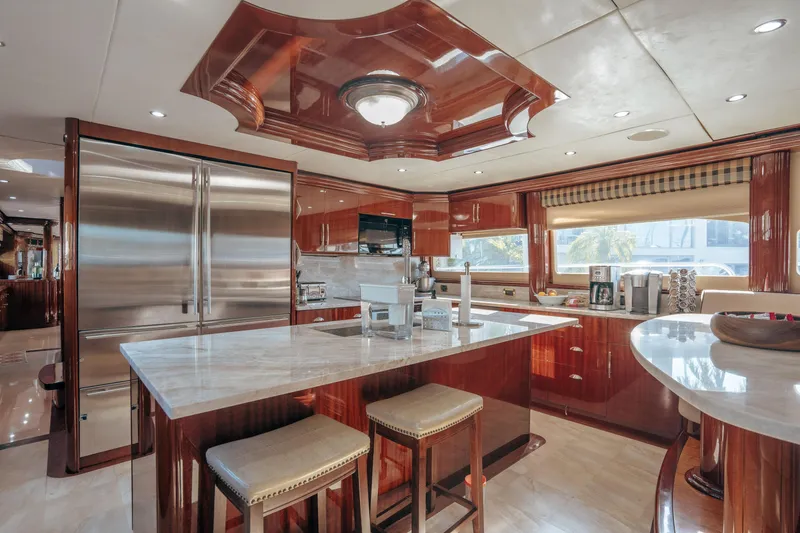 Slide: The Image of Luxurious kitchen interior on 2004 Lazzara 106 yacht with modern appliances and elegant wood finishes. - 49