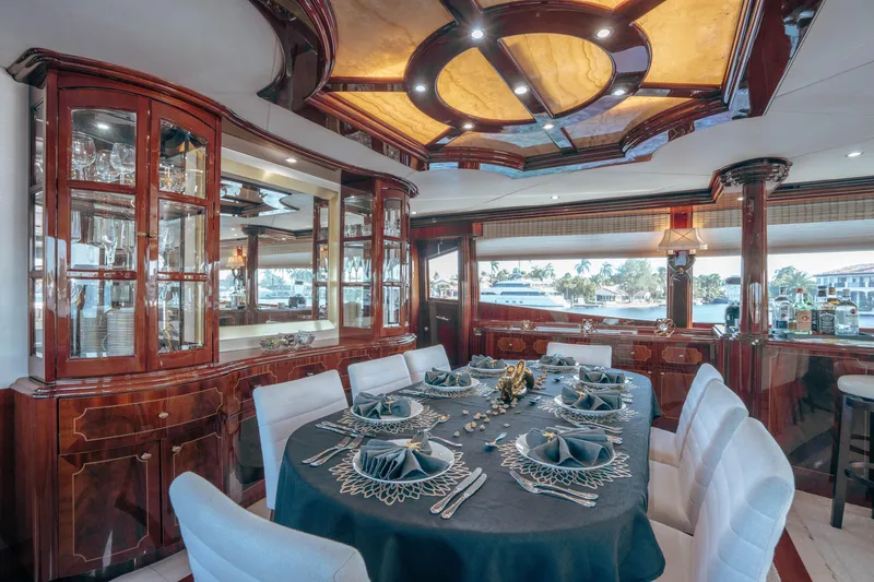 Slide: The Image of Luxurious dining area on 2004 Lazzara 106 yacht with elegant table setting and wood cabinetry. - 45