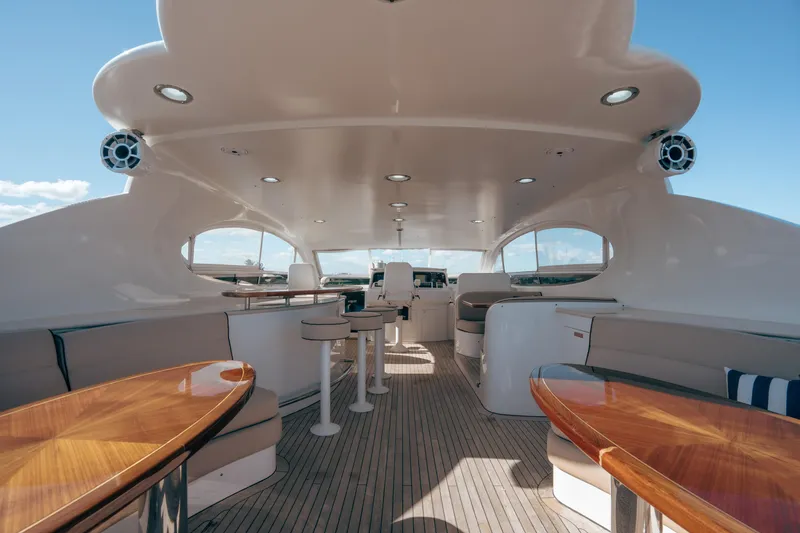 Slide: The Image of Luxurious 2004 Lazzara 106 yacht interior with elegant seating and polished wood tables. - 14