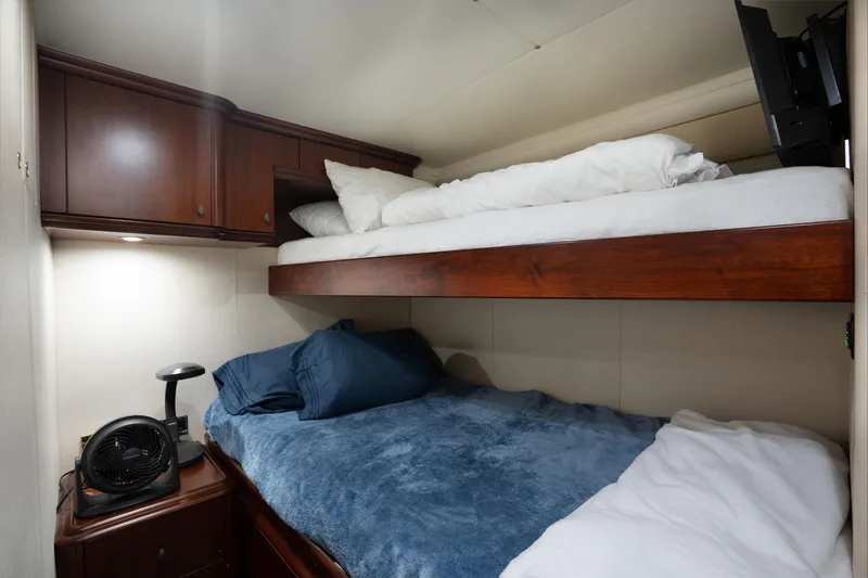 Slide: The Image of Cozy bunk beds in 2004 Lazzara 106 yacht cabin with wooden cabinets. - 67