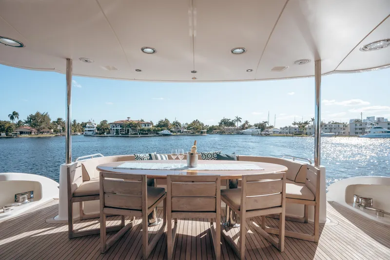 Slide: The Image of Luxury yacht deck with dining area overlooking serene waterfront, Lazzara 106, 2004 model. - 25