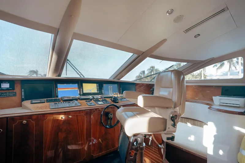 Slide: The Image of Luxurious helm of 2004 Lazzara 106 yacht with advanced navigation systems and leather captain's chair. - 51