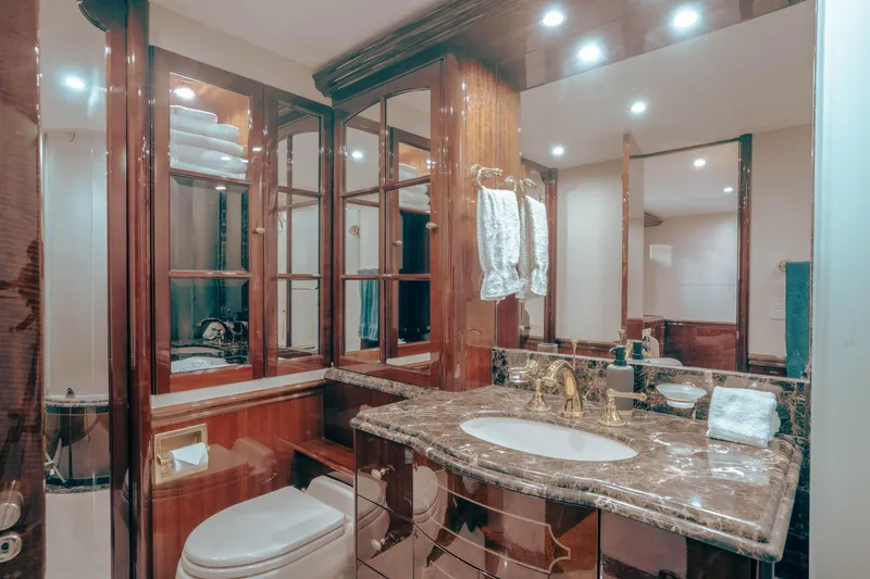 Slide: The Image of Luxurious bathroom in 2004 Lazzara 106 yacht with marble countertop and elegant wood cabinetry. - 56