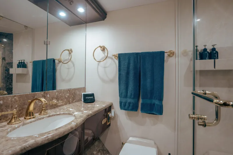Slide: The Image of Luxurious bathroom in 2004 Lazzara 106 yacht with marble countertop and gold fixtures. - 57