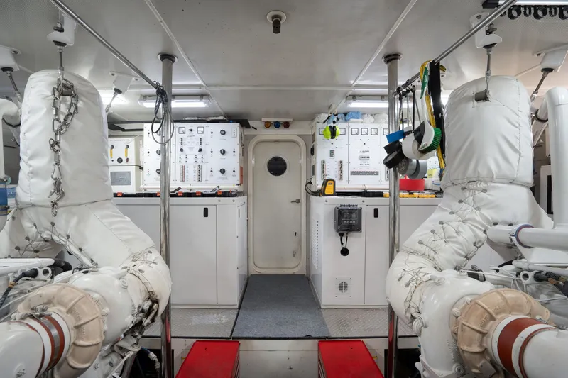 Slide: The Image of Engine room of 2004 Lazzara 106 yacht with control panels and insulated machinery. - 71