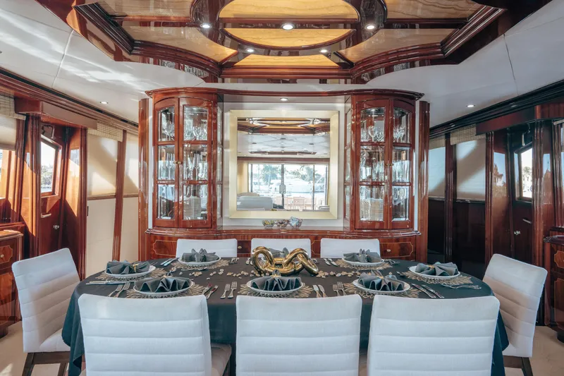 Slide: The Image of Luxurious dining area on 2004 Lazzara 106 yacht with elegant wood finishes and table setting. - 44