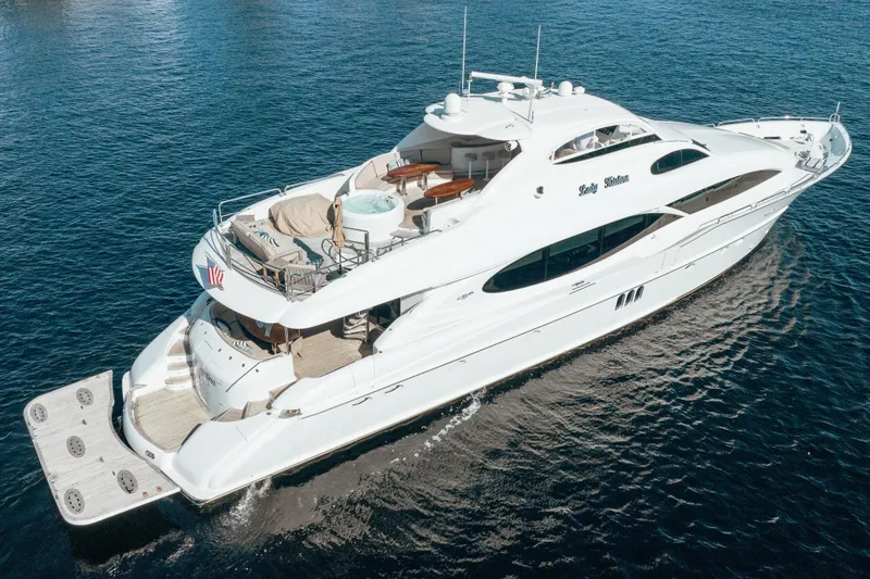 Slide: The Image of Luxurious 2004 Lazzara 106 yacht cruising on open water, featuring elegant design and spacious deck. - 1