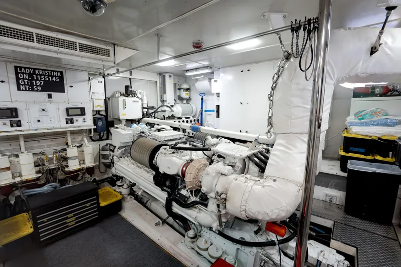 Slide: The Image of Engine room of 2004 Lazzara 106 yacht, featuring machinery and control panels. - 73