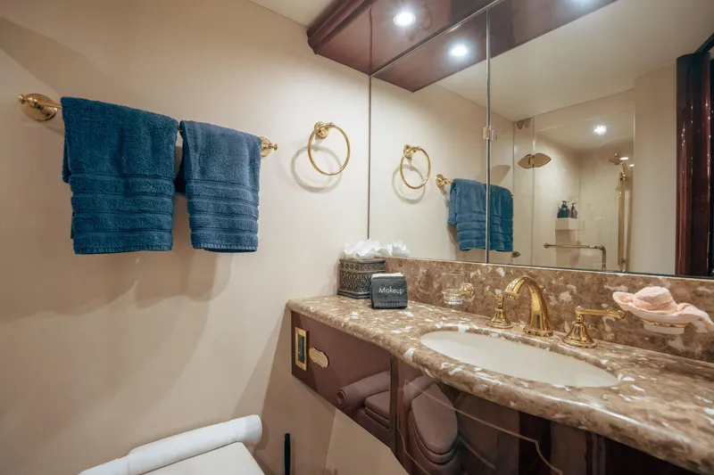 Slide: The Image of Luxurious bathroom in 2004 Lazzara 106 yacht with marble countertop and gold fixtures. - 53