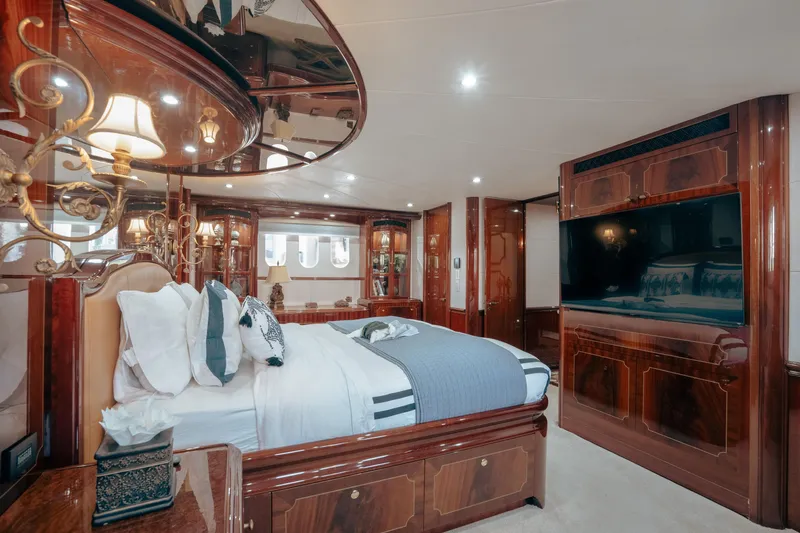 Slide: The Image of Luxurious bedroom interior on 2004 Lazzara 106 yacht with elegant wood finishes and plush bedding. - 38