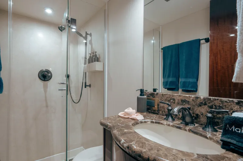 Slide: The Image of Luxurious bathroom in 2004 Lazzara 106 yacht with marble countertop and glass shower. - 40