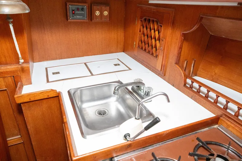Slide: The Image of 1979 C&L Marine 36 yacht kitchen with wooden cabinetry and stainless steel sink. - 30