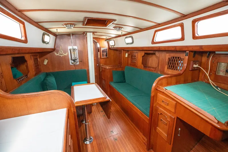 Slide: The Image of Interior of 1979 C&L Marine 36 sailboat with wooden furnishings and green upholstery. - 20