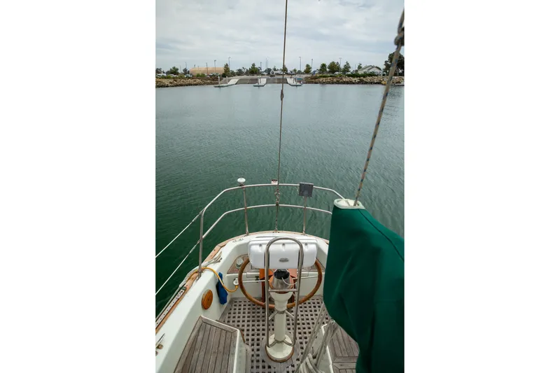 Slide: The Image of 1979 C&L Marine 36 sailboat cockpit view, overlooking calm waters and distant shoreline. - 14