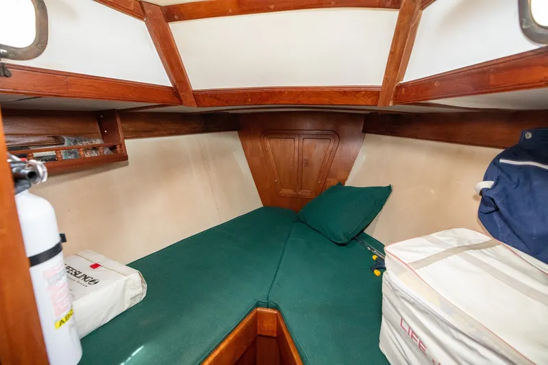 Slide: The Image of Cozy cabin interior of a 1979 C&L Marine 36 sailboat with green bedding. - 33