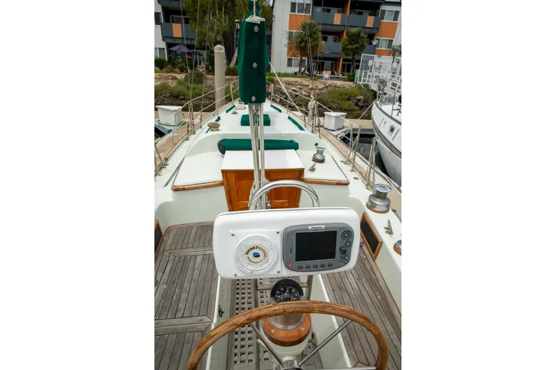 Slide: The Image of 1979 C&L Marine 36 sailboat cockpit with steering wheel and navigation equipment. - 13