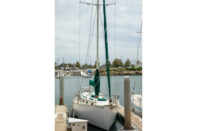 Slide: The Image of 1979 C&L Marine 36 sailboat docked in a marina, featuring green sail covers. - 5