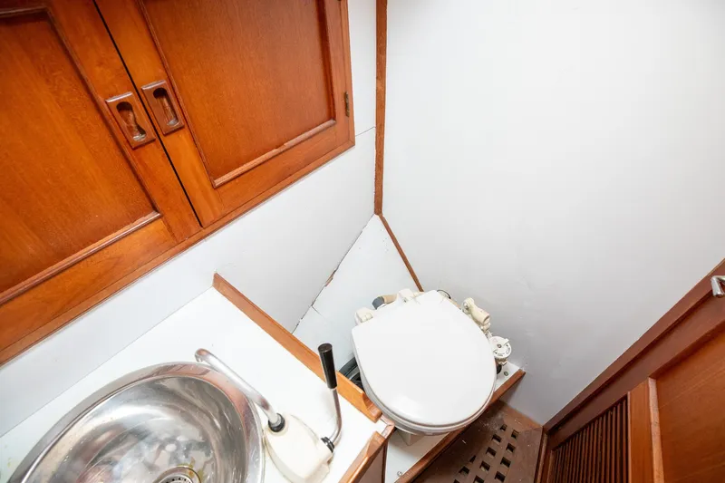 Slide: The Image of 1979 C&L Marine 36 boat bathroom with wooden cabinets and compact sink. - 40