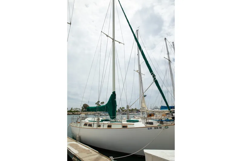 Slide: The Image of 1979 C&L Marine 36 sailboat docked at marina under cloudy sky. - 3
