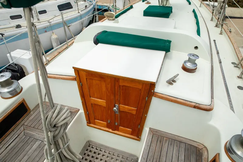 Slide: The Image of 1979 C&L Marine 36 sailboat deck with wooden hatch and green covers. - 8