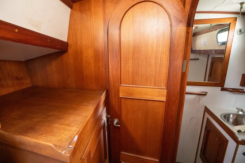 Slide: The Image of Wooden interior of 1979 C&L Marine 36 boat, featuring cabinetry and a small sink area. - 37