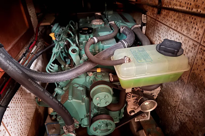 Slide: The Image of Engine compartment of a 1979 C&L Marine 36 boat, featuring hoses and components. - 43