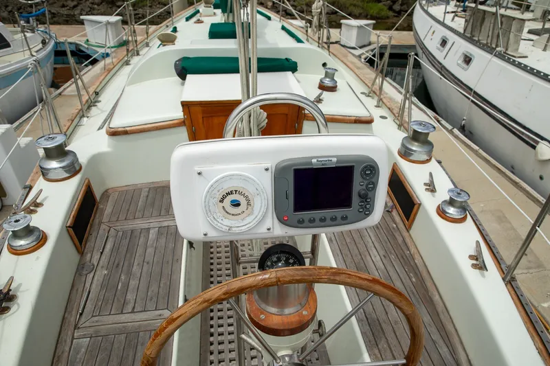 Slide: The Image of Cockpit of a 1979 C&L Marine 36 sailboat with navigation equipment and wooden details. - 11