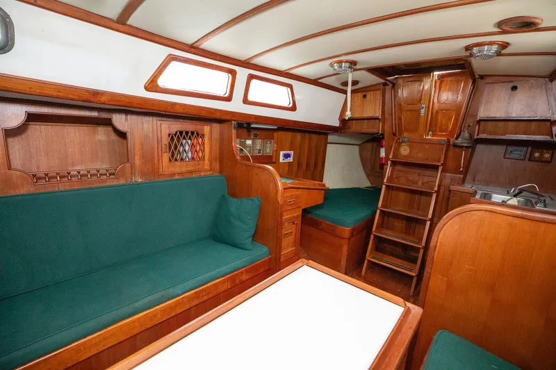 Slide: The Image of 1979 C&L Marine 36 yacht interior with wooden furnishings and green upholstery. - 22