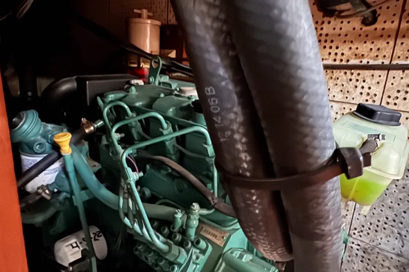 Slide: The Image of Engine compartment of a 1979 C&L Marine 36 boat, featuring hoses and components. - 47