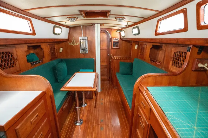 Slide: The Image of Interior of a 1979 C&L Marine 36 yacht with wooden furnishings and green upholstery. - 18