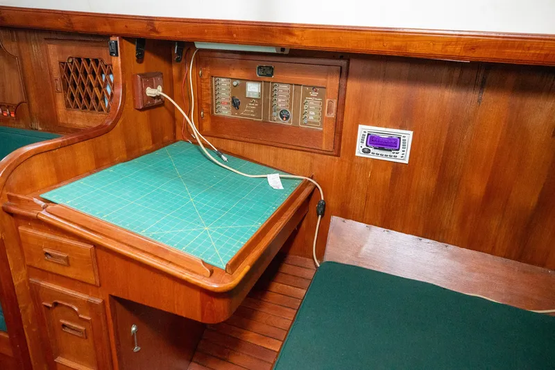 Slide: The Image of Wooden navigation station on a 1979 C&L Marine 36 sailboat, featuring control panels and storage. - 31
