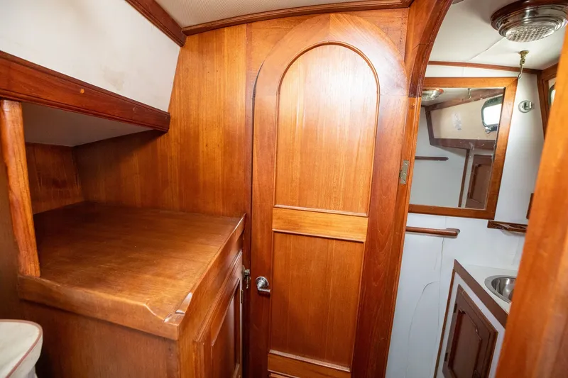 Slide: The Image of Wood-paneled interior of a 1979 C&L Marine 36 boat, featuring a door and mirror. - 38