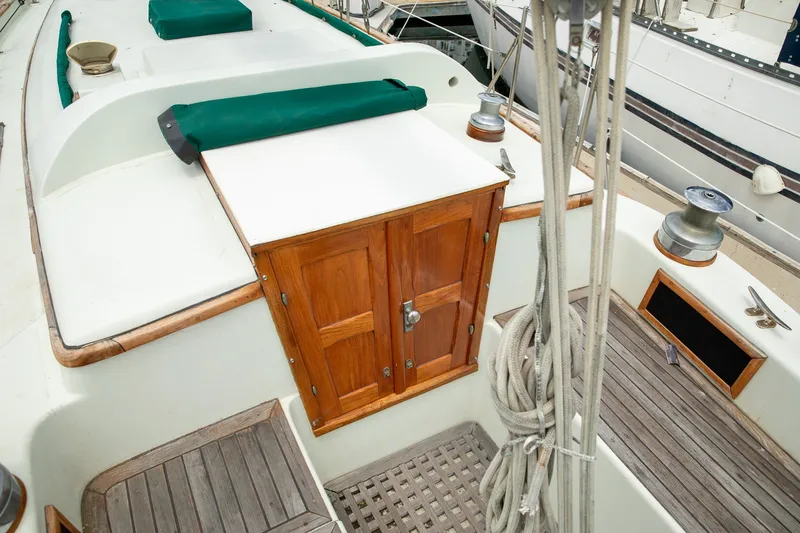 Slide: The Image of 1979 C&L Marine 36 sailboat cockpit with wooden hatch and green covers. - 7
