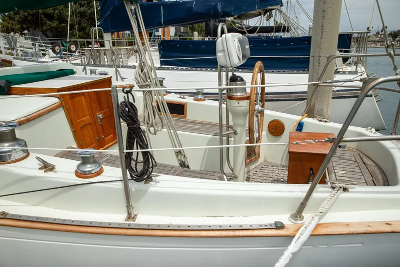 Slide: The Image of 1979 C&L Marine 36 sailboat cockpit with wooden accents and nautical equipment. - 15