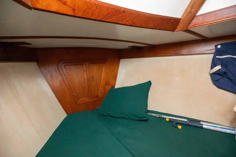 Slide: The Image of Cozy cabin interior of 1979 C&L Marine 36 sailboat with green bedding. - 35